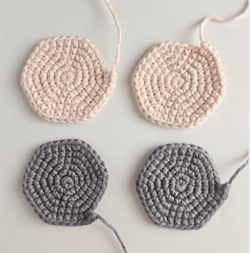 Upper elephant ears. Two large crocheted circles in pink and two large crocheted circles of exactly the same size in grey. This is for elephant ears as part of a free crochet elephant lovey pattern.